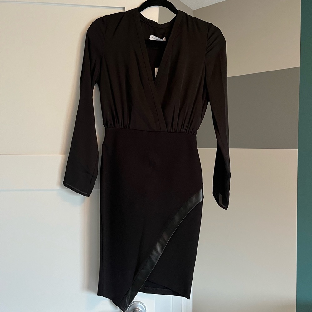 Classy black cocktail dress, stunning on! Open back and leather detail. BNWT